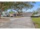 Single-story house with driveway and large oak tree at 289 Rafael Ne Blvd, St Petersburg, FL 33704