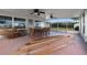 Screened porch with ceiling fans, table and chairs, and building materials at 289 Rafael Ne Blvd, St Petersburg, FL 33704