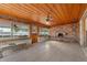 Cozy sunroom features wood-paneled ceilings, brick fireplace, tile flooring, and lots of natural light at 289 Rafael Ne Blvd, St Petersburg, FL 33704