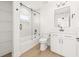 Bathroom featuring white vanity with marble countertop, black fixtures, and tub/shower at 3006 E Columbus Dr, Tampa, FL 33605