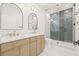 Modern bathroom with double vanity, glass shower, and unique tile work at 3006 E Columbus Dr, Tampa, FL 33605