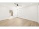 Bright, empty bedroom with white walls, light wood floors, and a ceiling fan at 3006 E Columbus Dr, Tampa, FL 33605
