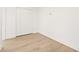 Empty bedroom with white walls, louvered closet doors, and light wood floors at 3006 E Columbus Dr, Tampa, FL 33605