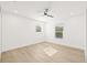 Bright bedroom with two windows, white walls, light wood floors, and ceiling fan at 3006 E Columbus Dr, Tampa, FL 33605
