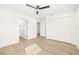 Large main bedroom with light wood floor, white closet doors, and ceiling fan at 3006 E Columbus Dr, Tampa, FL 33605