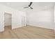 Large bedroom with walk-in closet, ceiling fan, and wood-look flooring at 3006 E Columbus Dr, Tampa, FL 33605