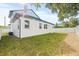 Back view of the house with white exterior and fenced yard at 3006 E Columbus Dr, Tampa, FL 33605