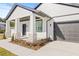 Close-up of the front porch with brick accents, white columns, and a dark front door at 3006 E Columbus Dr, Tampa, FL 33605
