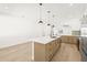 Modern kitchen with white and wood cabinets, a large island, and pendant lights at 3006 E Columbus Dr, Tampa, FL 33605