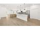 Open kitchen with an island, stainless steel appliances, and wood-style flooring at 3006 E Columbus Dr, Tampa, FL 33605