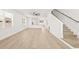 Spacious living room with wood floors, white walls, and a view into the kitchen at 3006 E Columbus Dr, Tampa, FL 33605