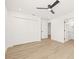 Spacious main bedroom with white walls, light wood floors, ceiling fan, and large closet at 3006 E Columbus Dr, Tampa, FL 33605