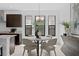 Dining area with round table, modern light fixture, and view of the kitchen at 432 43Rd Ne Ave, St Petersburg, FL 33703