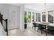 Dining area with modern light fixture, large windows, and stylish furniture at 432 43Rd Ne Ave, St Petersburg, FL 33703
