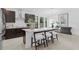 Stylish kitchen with dark wood cabinets, an island with barstools, and modern art at 432 43Rd Ne Ave, St Petersburg, FL 33703