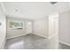 Spacious entryway with light grey flooring, white door, and hallway at 4504 W Price Ave, Tampa, FL 33611