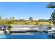 Luxury pool area with golf course views, white balustrade, and blue skies at 6307 Pasadena Point Blvd, Gulfport, FL 33707