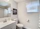 Clean bathroom with white vanity, toilet, and shower at 6371 Shadydale Ave, Spring Hill, FL 34609