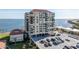 Aerial view of waterfront condo building with parking and surrounding landscape at 6372 Palma Del Mar S Blvd # 505, St Petersburg, FL 33715