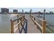 Private dock extending into the water, offering a serene spot for relaxation and boating at 8020 Coquina Way, St Pete Beach, FL 33706