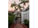 Ornate iron gate entry with brick walkway and lush landscaping at 128 Boca Ciega Point N Blvd, St Petersburg, FL 33708