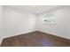 Simple bedroom with hardwood floors and a window offering natural light at 2050 Bayou Grande Ne Blvd, St Petersburg, FL 33703