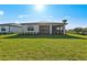 Well-maintained backyard with lush lawn and covered lanai at 3065 Winding Creek Trl, North Port, FL 34289