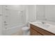 Clean bathroom with a shower and tub, complemented by a vanity with light wood cabinets and a white countertop at 3065 Winding Creek Trl, North Port, FL 34289