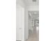 Bright hallway with tile flooring, leading to various rooms, offering a clear sense of spaciousness at 3065 Winding Creek Trl, North Port, FL 34289