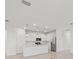 Bright, all-white kitchen featuring stainless steel appliances, quartz countertops, and stylish pendant lighting at 3065 Winding Creek Trl, North Port, FL 34289