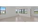 Bright living room featuring an open floor plan and large windows that let in natural light at 3065 Winding Creek Trl, North Port, FL 34289