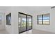 Bright living room featuring an open floor plan, a sliding glass door, and large windows that let in natural light at 3065 Winding Creek Trl, North Port, FL 34289