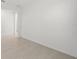 Minimalist room with neutral tile flooring and bright walls, creating a versatile space for any use at 3065 Winding Creek Trl, North Port, FL 34289