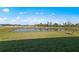 Peaceful view of a pond and greenery from the backyard at 3065 Winding Creek Trl, North Port, FL 34289