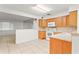 Open kitchen with oak cabinets and white appliances at 309 W Louisiana Ave, Tampa, FL 33603