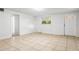 Bright living room with tile floors and access to other rooms at 309 W Louisiana Ave, Tampa, FL 33603