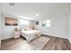 Bright bedroom with wood-look floors and an accent wall at 3534 Bluebird Dr, New Port Richey, FL 34652