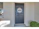 Dark gray front door with a welcome sign at 3534 Bluebird Dr, New Port Richey, FL 34652