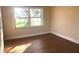 Empty room with wood-look flooring and large window at 4409 W Paris St, Tampa, FL 33614