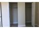 Double closet with open doors and hanging rods at 4409 W Paris St, Tampa, FL 33614