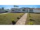 Front yard of a renovated home with lush green grass and a welcoming walkway at 4516 N Jamaica St, Tampa, FL 33614