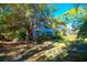 Two-story house partially hidden behind lush vegetation at 5400 Bates St, Seminole, FL 33772