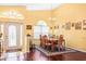 Formal dining room with hardwood floors, chandelier, and large windows at 641 Westfield Ct, Dunedin, FL 34698