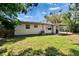 Backyard features mature shade trees and covered patio at 6524 14Th N St, St Petersburg, FL 33702