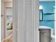 Modern bathroom with blue accent wall, shelving, vanity, and toilet at 6524 14Th N St, St Petersburg, FL 33702