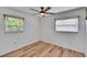 Minimalist bedroom with natural light, wood-look flooring, and windows with blinds at 6524 14Th N St, St Petersburg, FL 33702