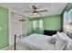 Bright bedroom features neutral walls, wood-look flooring, fan, and closet at 6524 14Th N St, St Petersburg, FL 33702
