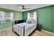 Comfortable bedroom with a metal frame bed, stylish decor, and natural light from the windows at 6524 14Th N St, St Petersburg, FL 33702