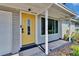 Inviting home entrance with a bright yellow door and well-maintained front porch at 6524 14Th N St, St Petersburg, FL 33702