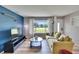 Comfortable living room featuring a large window with a view, a sofa, and modern decor at 6524 14Th N St, St Petersburg, FL 33702